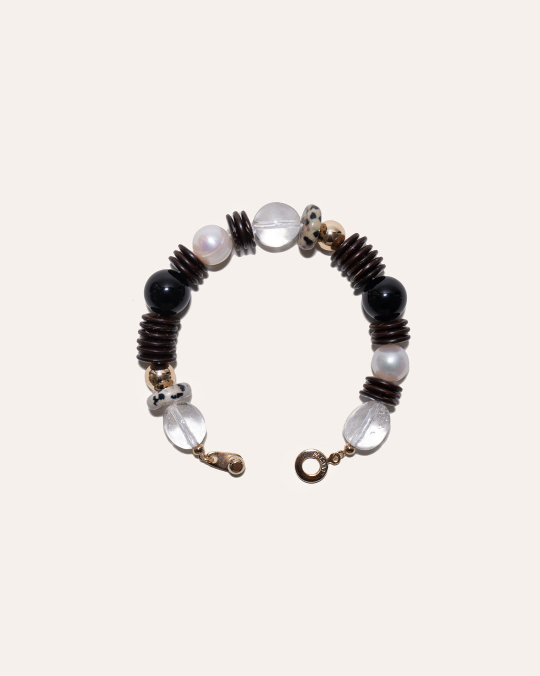 Earth Mix bracelet featuring coconut disc beads, clear quartz, dalmatian jasper, black onyx, and gold beads.