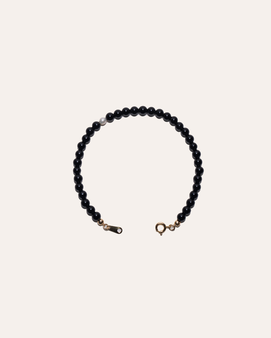 Gem & One bracelet featuring black onyx and freshwater pearl beads.