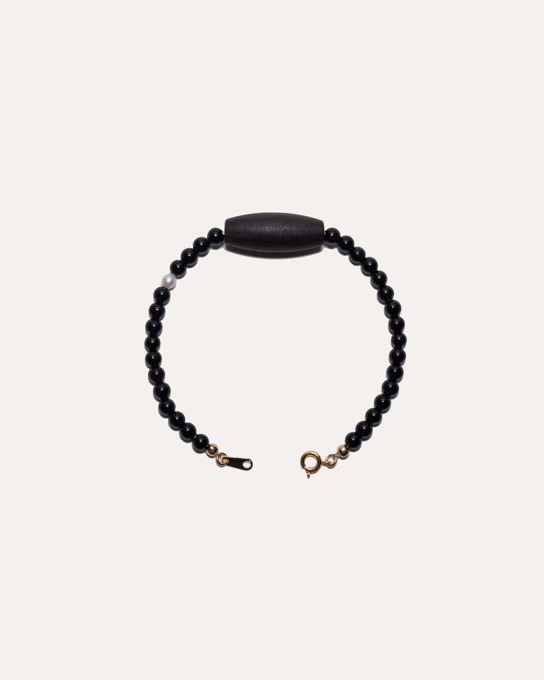 Gem & One Rooted bracelet with oval dark rosewood bead, black onyx, and freshwater pearl.