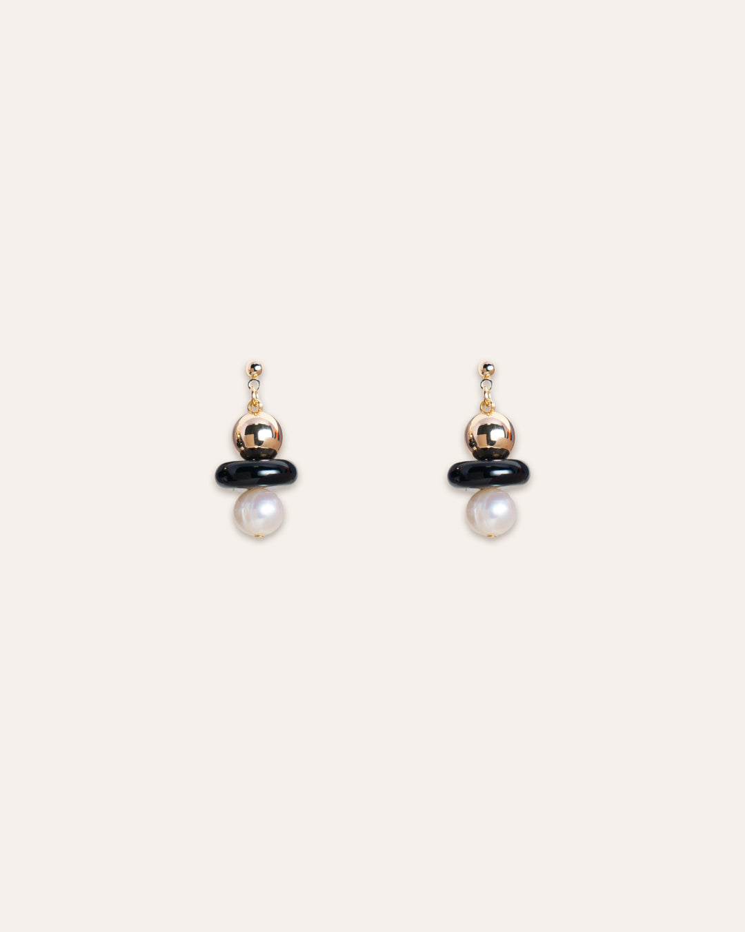 Luxurious 14k gold vermeil Stella earrings featuring delicate onyx and lustrous freshwater pearls, set against a minimalist background for emphasis.