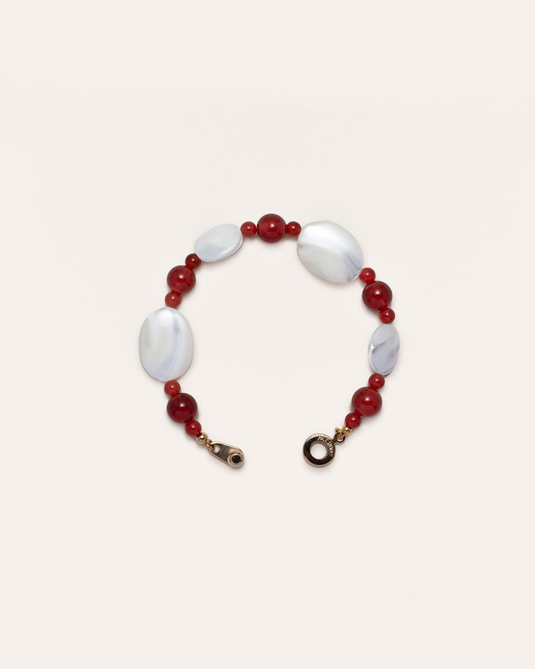 A captivating Sonata Moonlit Bracelet, handcrafted from exquisite red agate and delicate mother of pearl, presents a timeless accessory for women.