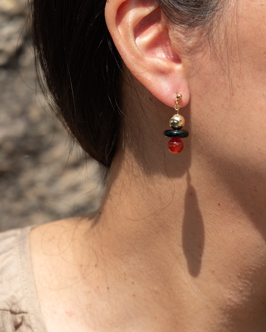 Stella earrings with stylish 14k gold vermeil ball earrings featuring a combination of onyx and vibrant red agate gemstones, ideal for everyday wear or special occasions.