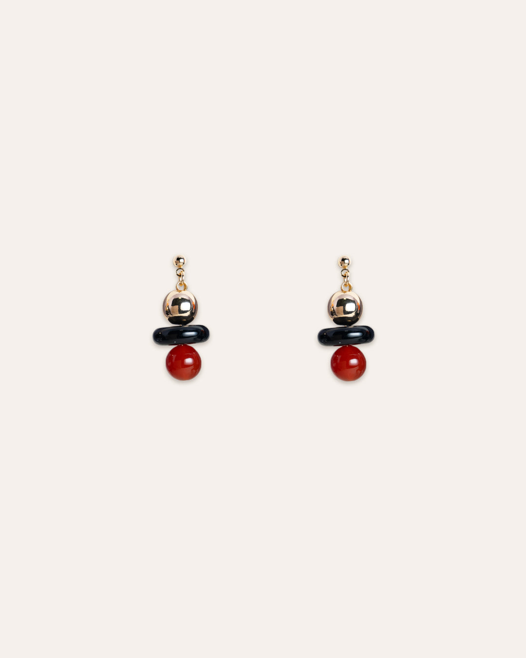 Elegant Stella Earrings featuring a vibrant red agate gemstone suspended from a 14k gold vermeil ball, set against a contrasting onyx backdrop. A statement accessory for women, perfect for evening wear.
