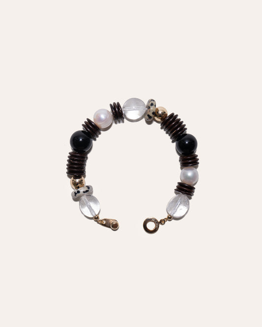 Earth Mix bracelet featuring coconut disc beads, clear quartz, dalmatian jasper, black onyx, and gold beads.
