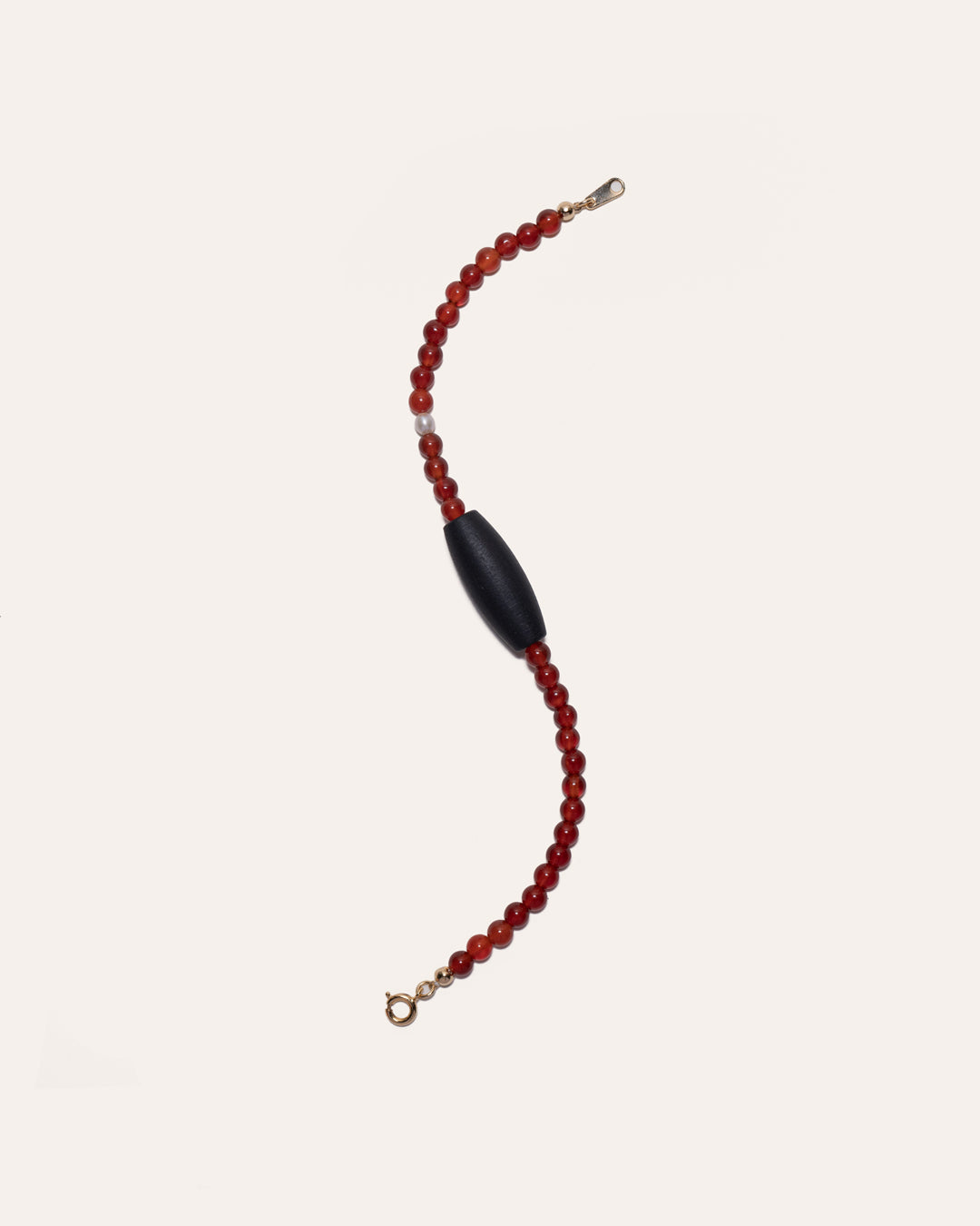 Gem & One Rooted bracelet with oval dark rosewood bead, red agate, and freshwater pearl.
