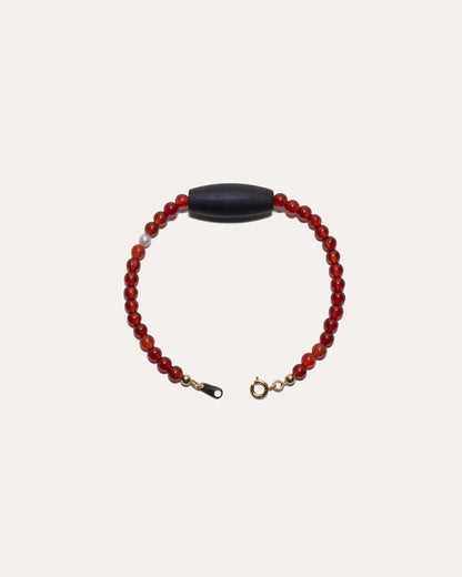 Gem & One Rooted bracelet with oval dark rosewood bead, red agate, and freshwater pearl.