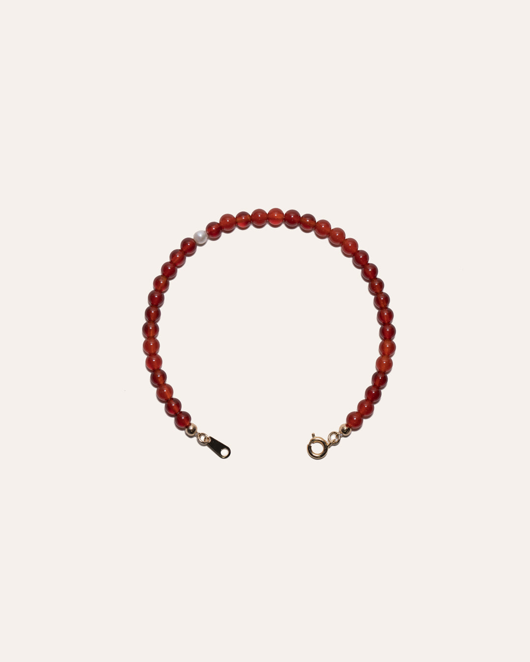 Gem & One bracelet featuring red agate and freshwater pearl beads.
