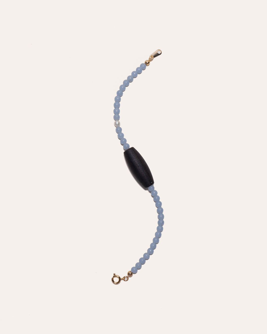 Gem & One Rooted bracelet with oval dark rosewood bead, angelite, and freshwater pearl.
