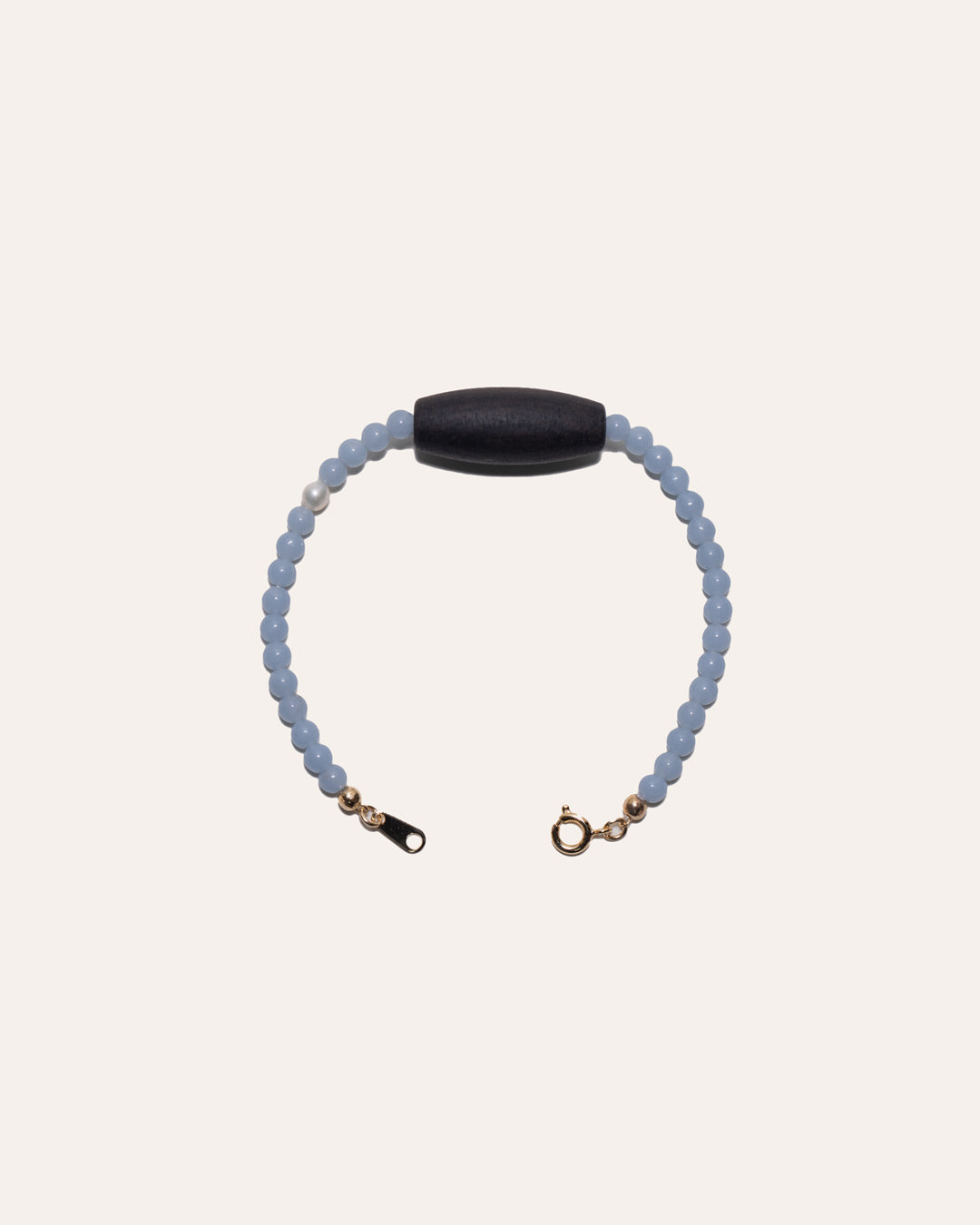 Gem & One Rooted bracelet with oval dark rosewood bead, angelite, and freshwater pearl.
