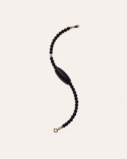 Gem & One Rooted bracelet with oval dark rosewood bead, black onyx, and freshwater pearl.