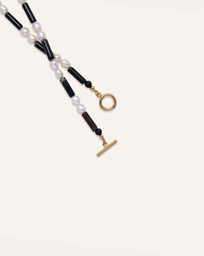 Rhythm necklace featuring freshwater pearls and onyx keys, designed for style and individuality. 
