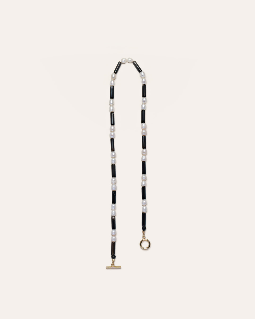 Rhythm necklace in black and white, featuring a freshwater pearls and onyx beads, showcasing elegant jewelry craftsmanship. 