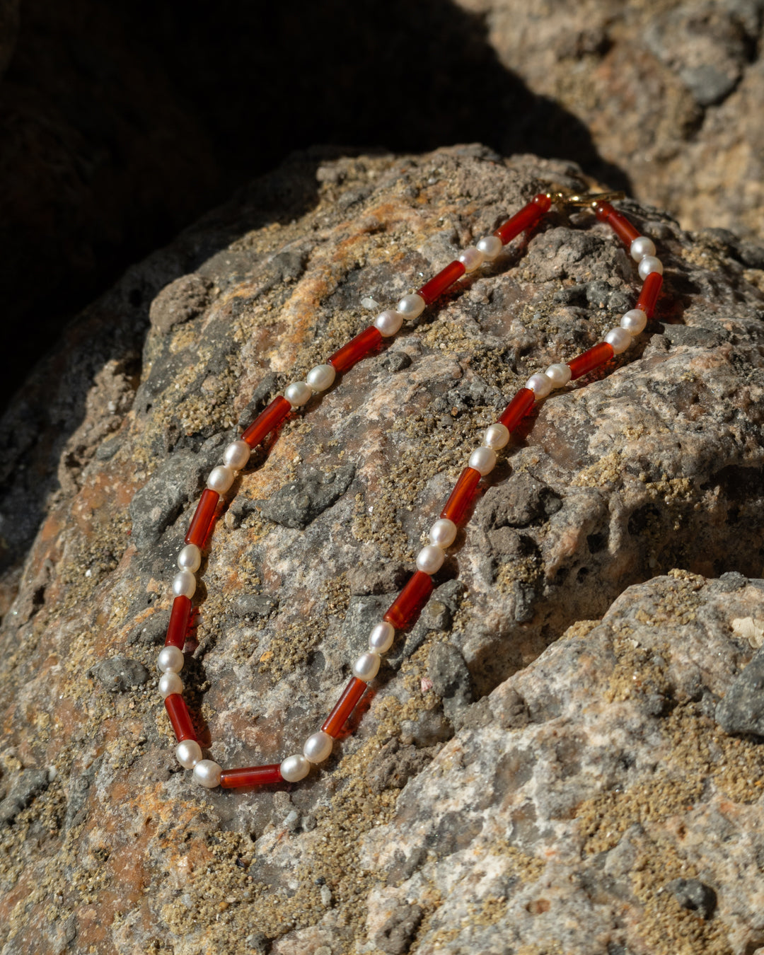 A freshwater pearl and red agate Rhythm Necklace, a stylish accessory for jewelry enthusiasts. 