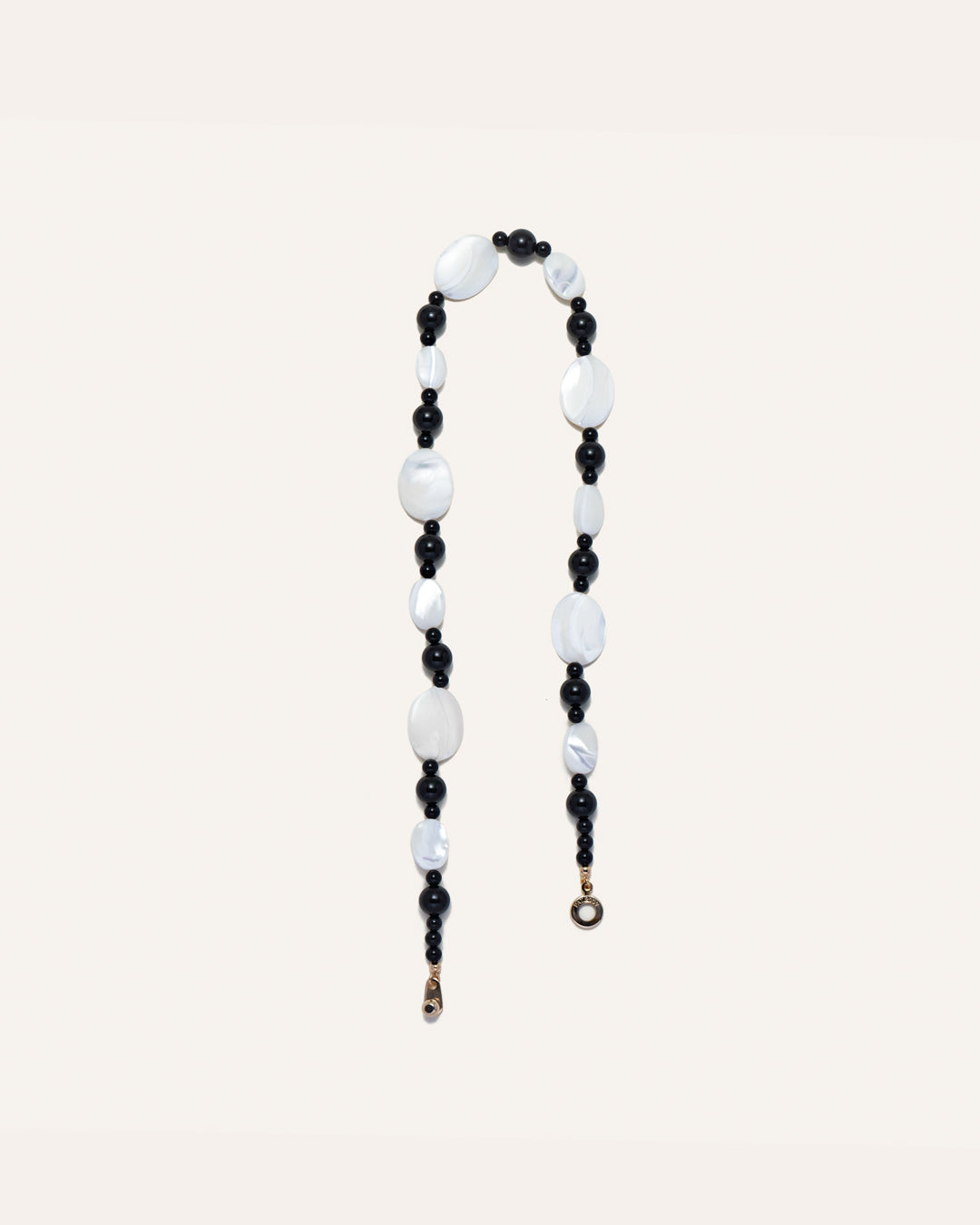 Sonata Moonlit Necklace, a striking combination of mother of pearl (MOP) and onyx gemstones. The necklace features a beaded design that intertwines with the natural luster of MOP stones and the contrasting dark hue of onyx stones. This elegant necklace is perfect for both formal and casual occasions, bringing a touch of sophistication to any outfit. 