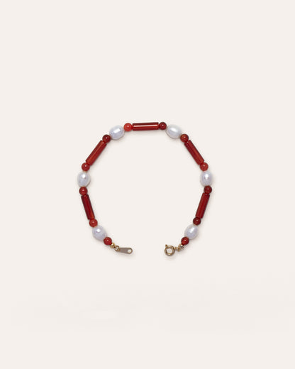 Starry Bracelet Red Agate featuring red agate and freshwater pearl, showcasing a delicate blend of natural stone and lustrous pearl on a wire bracelet. This handmade accessory is both stylish and unique, perfect for casual wear or as a statement piece. 