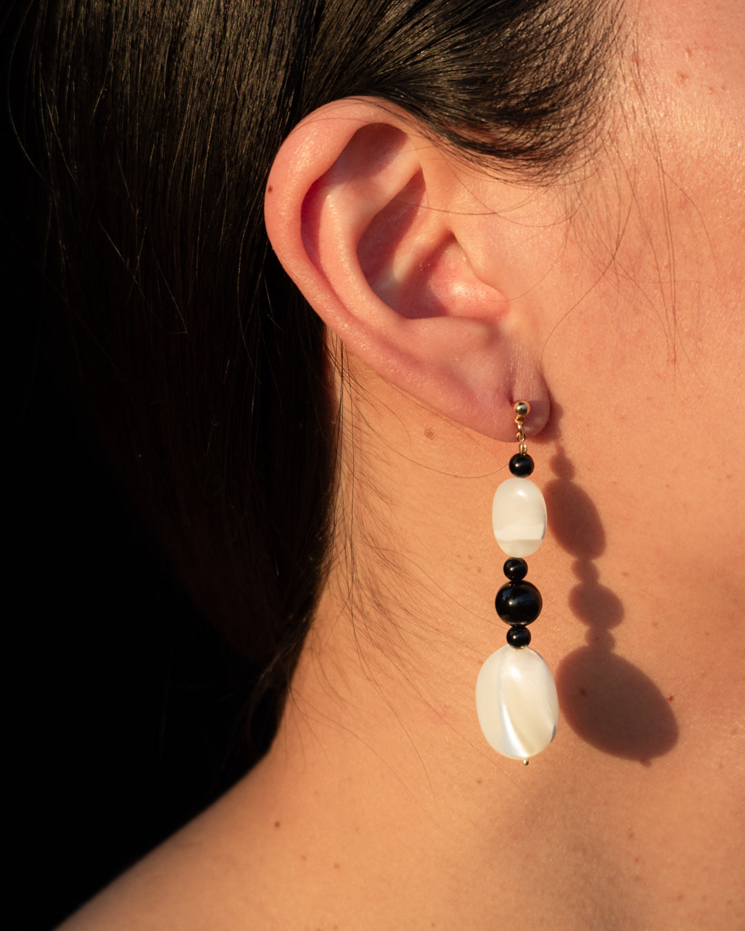 Moonlit Earrings Onyx - Mother Of Pearl (MOP) and Onyx earrings for women, showcasing elegance and sophistication in fashion jewelry. 