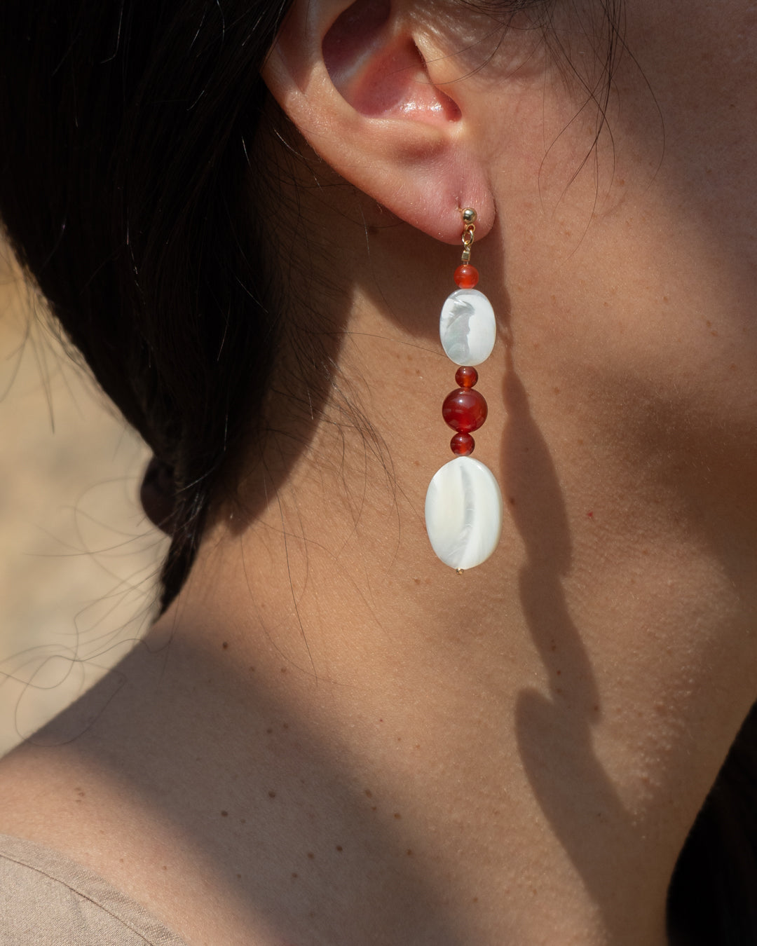 Moonlit Earrings: Red Agate Drop Earrings with Mother of Pearl Accents, featuring vibrant red stones and a touch of natural charm for an elegant accessory.