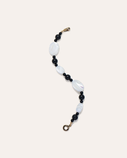 Sonata Moonlit Bracelet: Elegant Onyx and Mother of Pearl (MOP) Jewelry, laid flat in a s-shape. Fashion Accessory for Women, Handcrafted Design.
