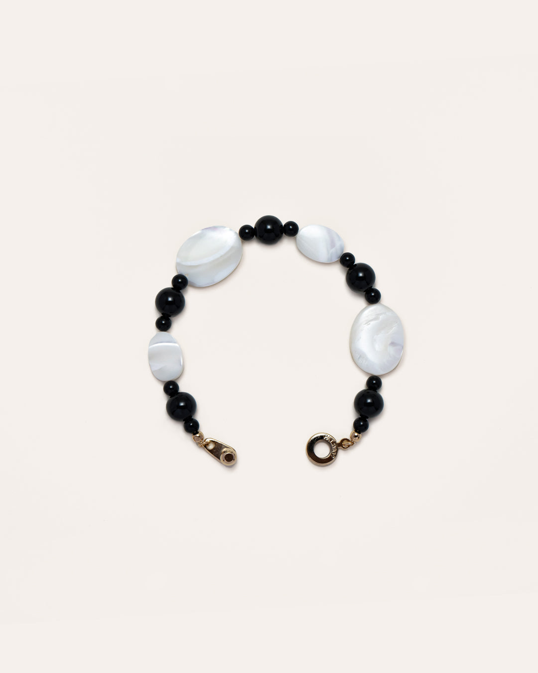 Sonata Moonlit Onyx Bracelet - Chic accessory featuring onyx stones and delicate mother of pearl inlay, set against a pink black background. A timeless piece that adds a touch of elegance to your daily style. 