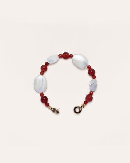 A captivating Sonata Moonlit Bracelet, handcrafted from exquisite red agate and delicate mother of pearl, presents a timeless accessory for women. 